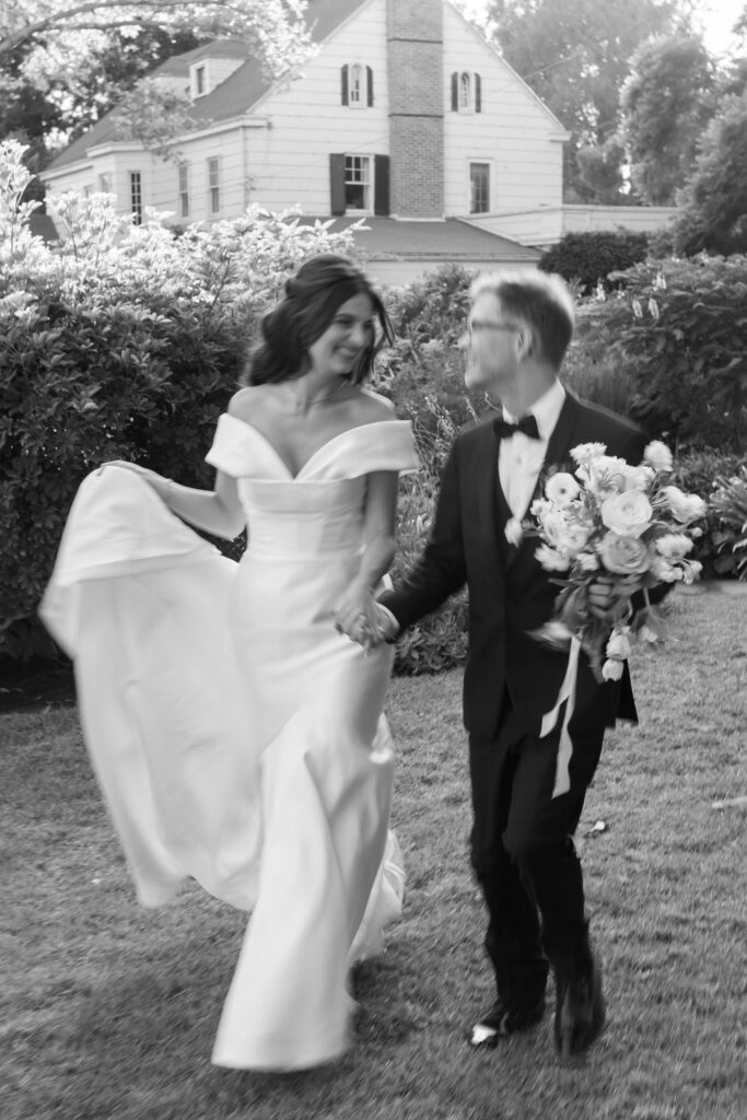 Blurry black and white photo of the bride and groom running together after their McCormick Home Ranch Wedding in Camarillo, CA.
