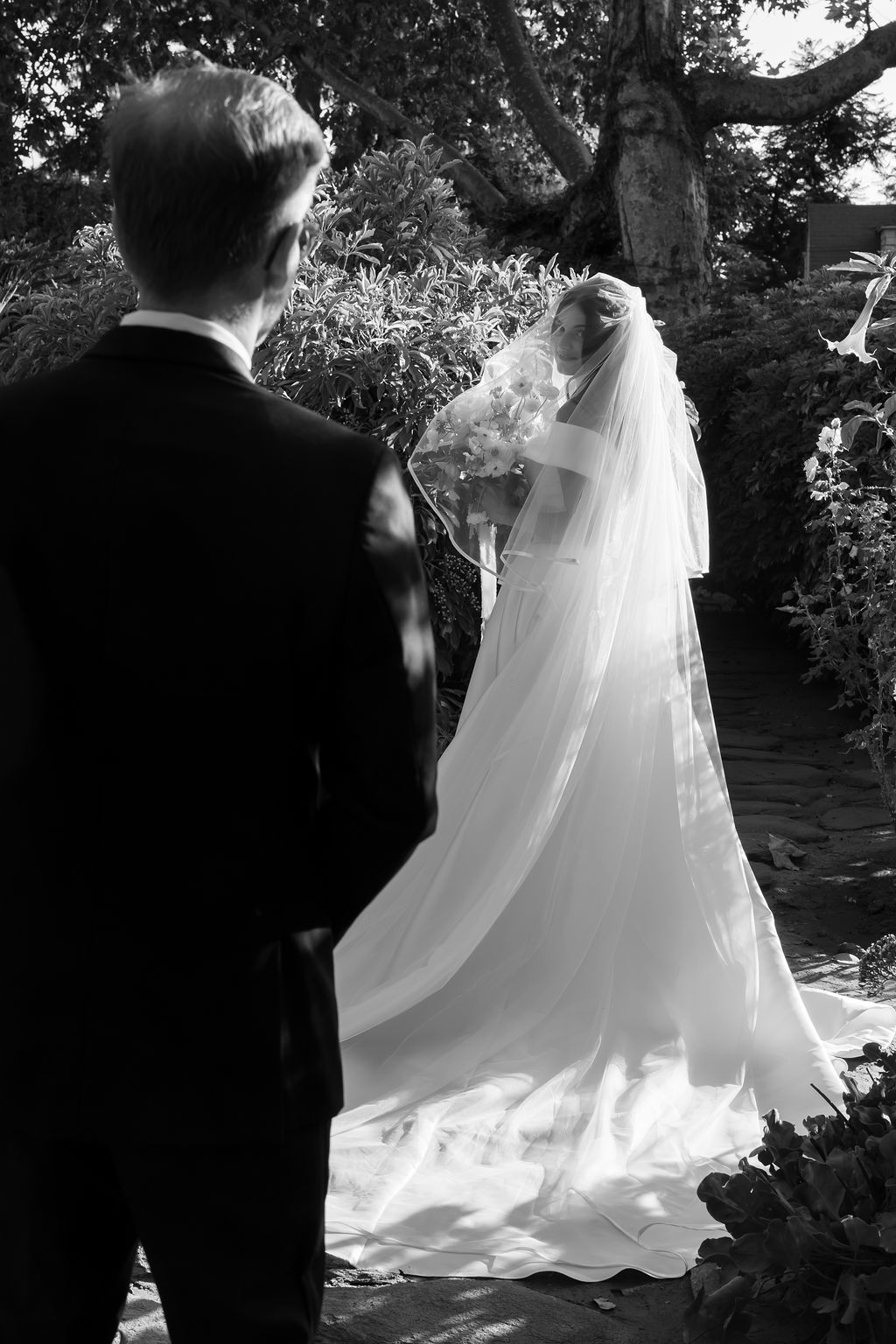 Groom admiring the bride as she stands in the garden during golden hour at McCormick Home Ranch.