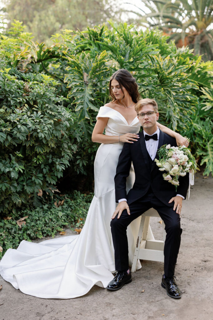 Bride and groom posing together near lush greenery on the 11-acre McCormick Home Ranch property.