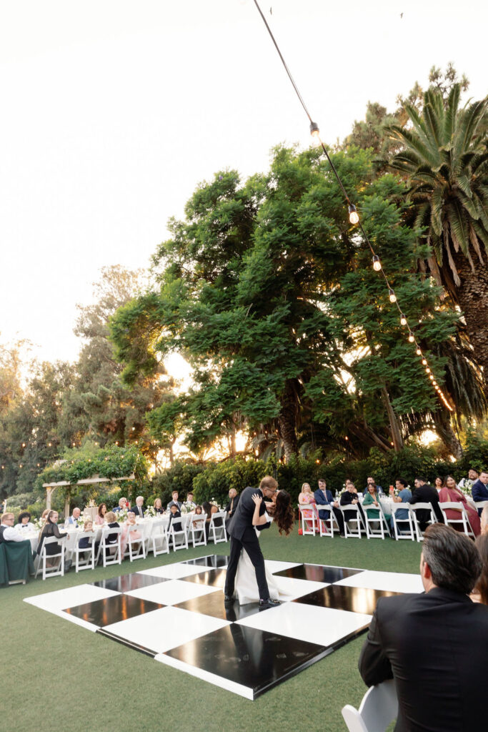 First dance on the black-and-white checkered dance floor during the McCormick Home Ranch wedding reception.