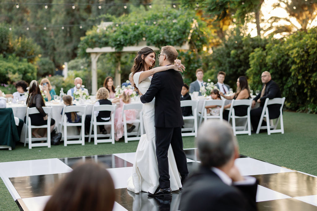First dance on the black-and-white checkered dance floor during the McCormick Home Ranch wedding reception.