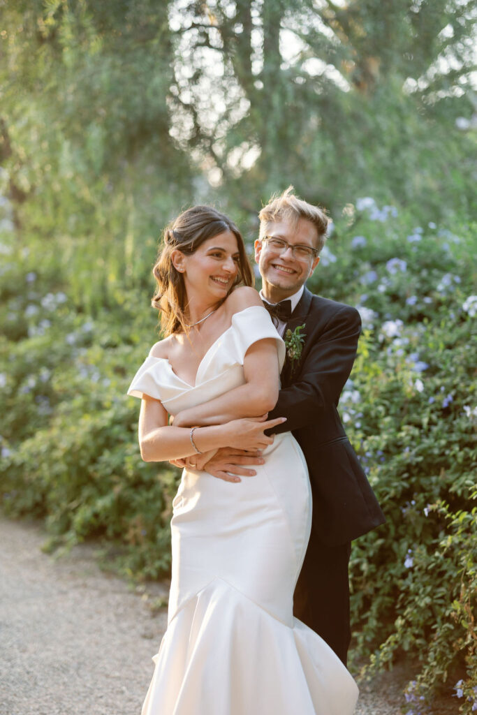 Couple embracing and smiling during golden hour portraits at McCormick Home Ranch.