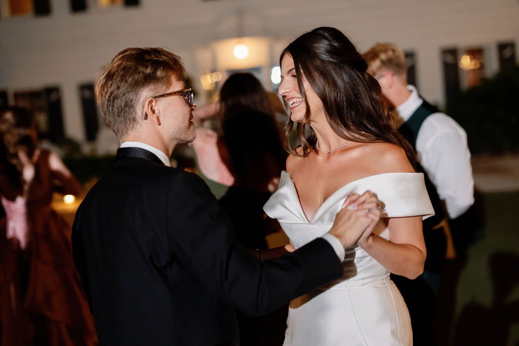 Close, intimate moment of the couple dancing under string lights at their McCormick Home Ranch wedding reception.