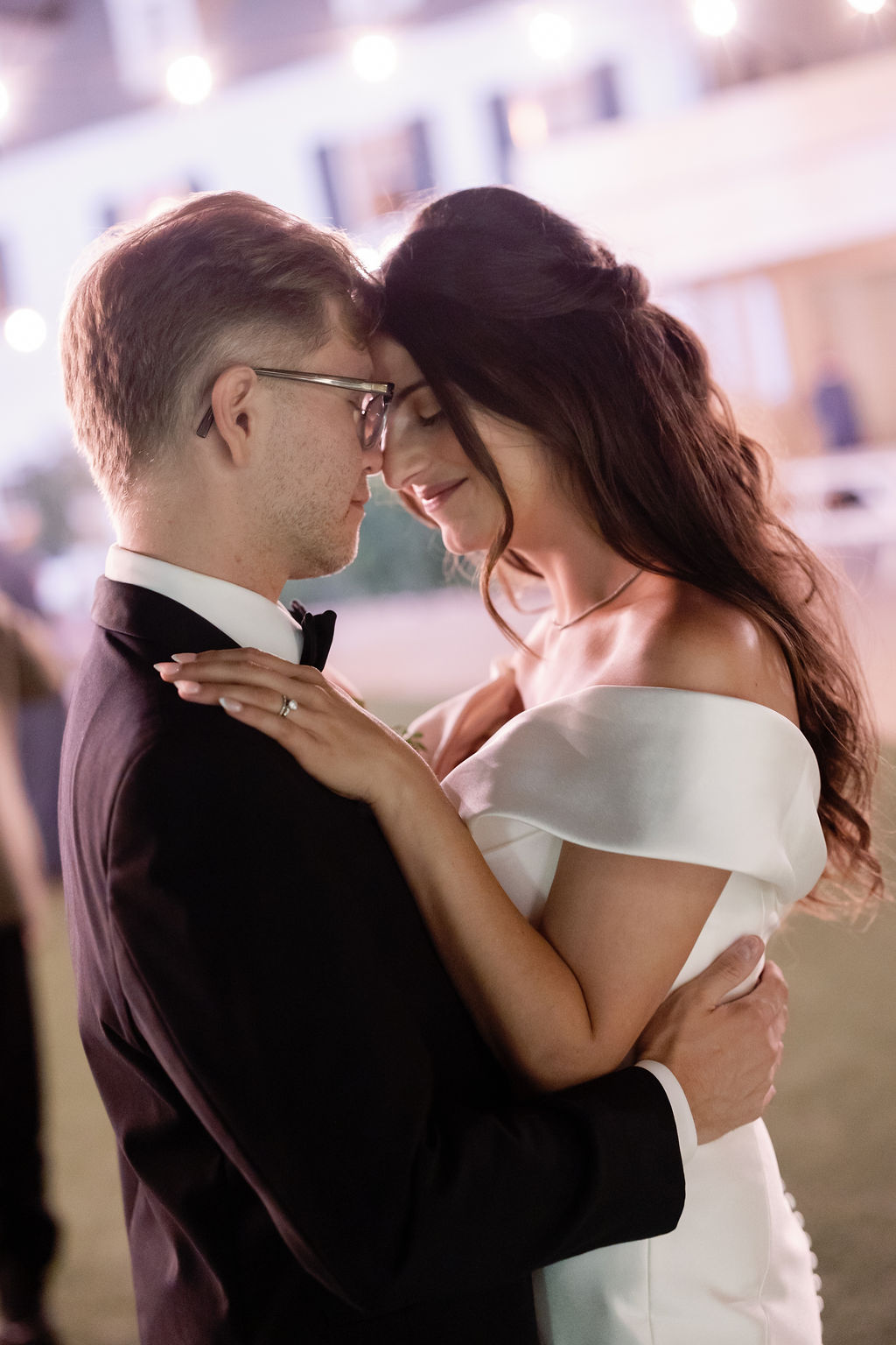 Bride and groom dancing under twinkling lights during their McCormick Home Ranch wedding in Southern California. 