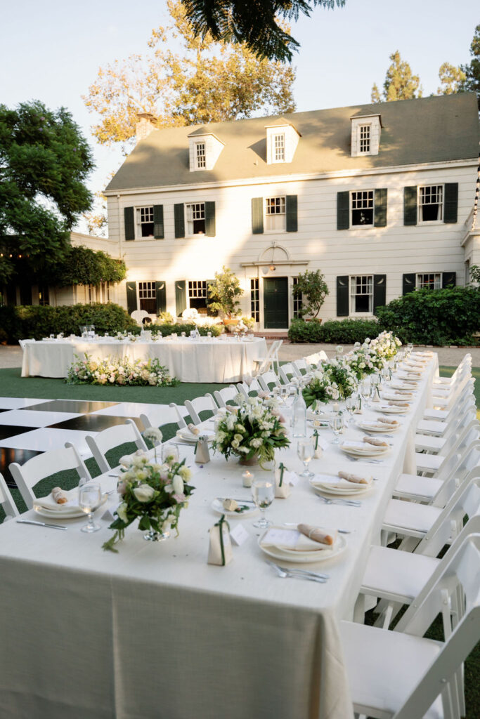 Reception tables arranged on the circular lawn in front of the historic home at McCormick Home Ranch wedding in Camarillo, CA.