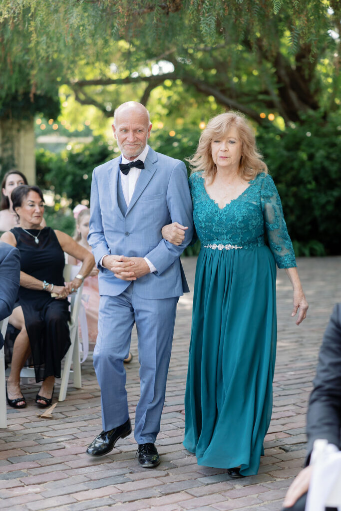 Parents of the groom walking down the aisle before the start of the ceremony