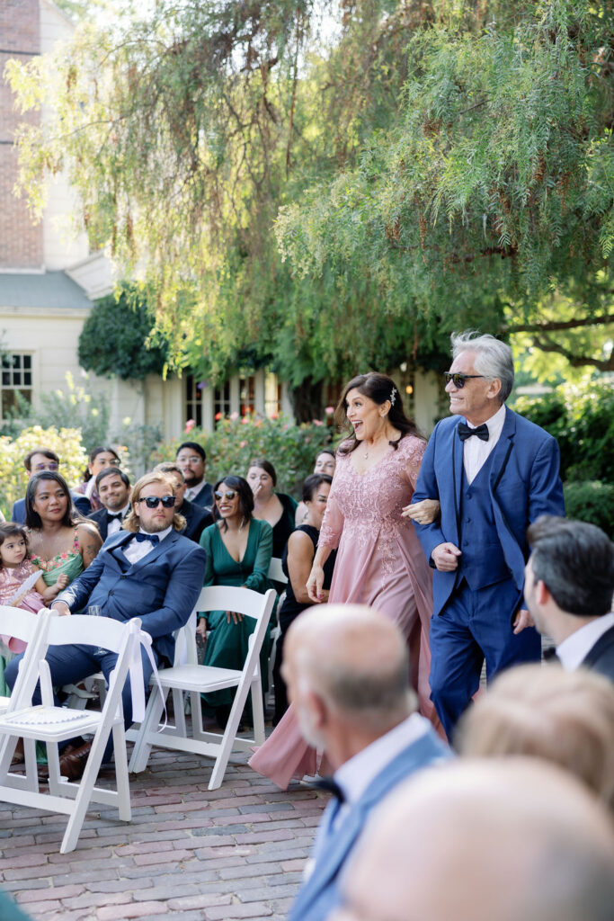 Parents of the bride walking down the aisle before the start of the ceremony