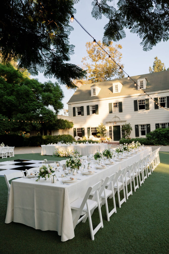 A whimsical and classic outdoor McCormick Home Ranch wedding reception setup during golden hour