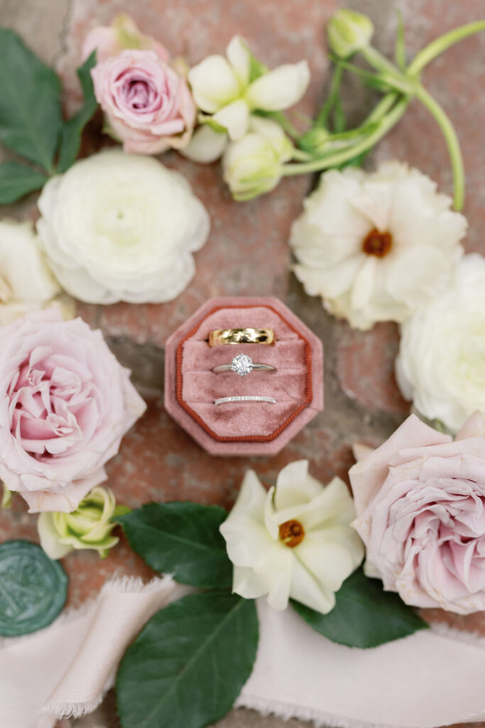 Rings and florals arranged on brick for detail photos at McCormick Home Ranch.