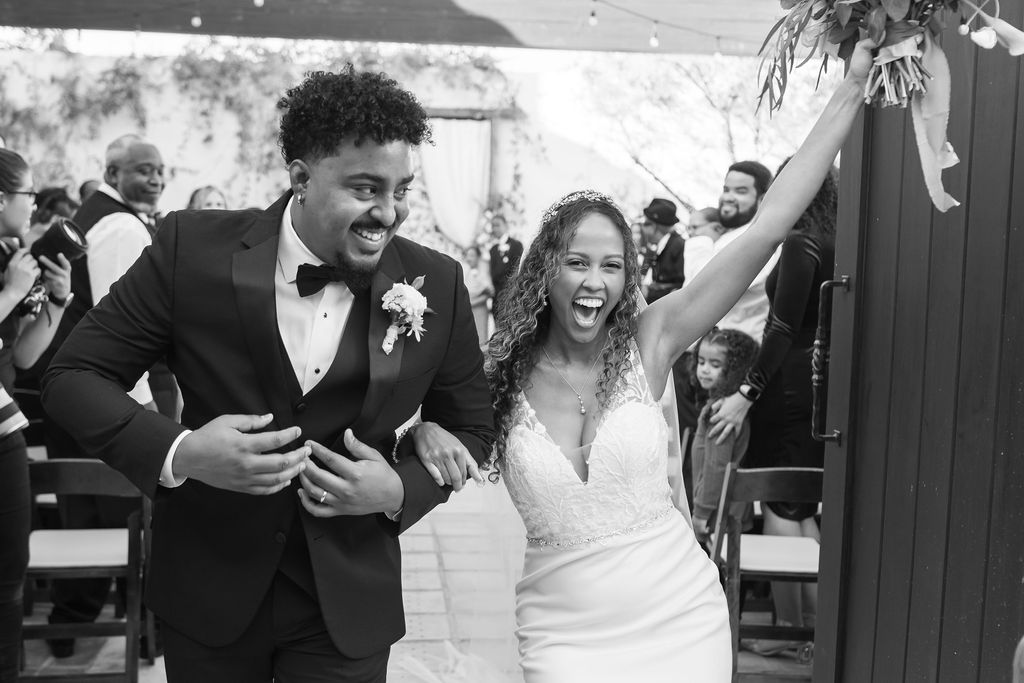 Black and white photo of a bride and groom after their La Ventura San Clemente wedding ceremony.