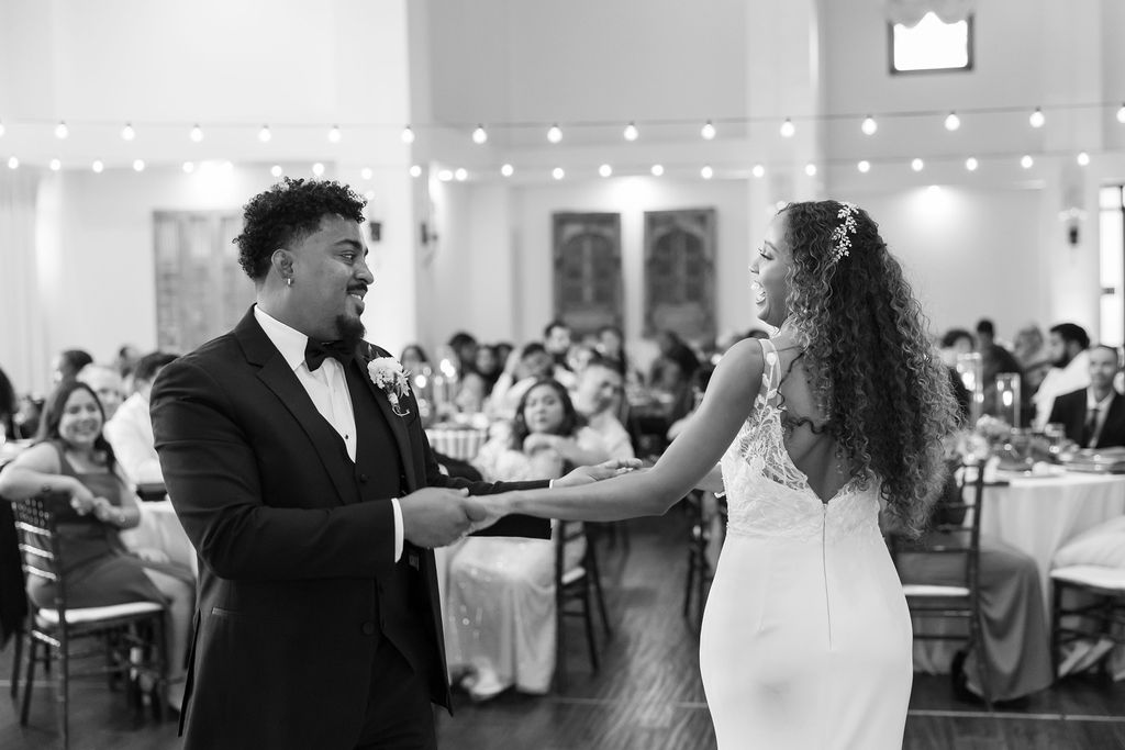 Black and white photo o a bride and groom dancing during their La Ventura San Clemente wedding reception in the Grand Parlour.