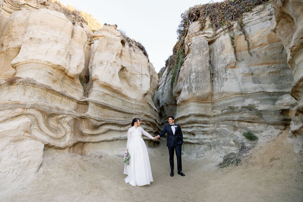 Bride and groom posing in front of San Clementes San Cliffs in SoCal