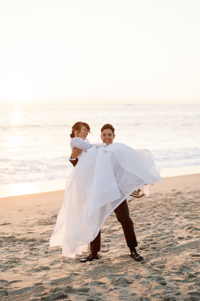 Bride and groom posing at Calafia State Beach in Southern California.