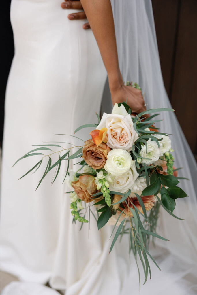 Close up shot of a bride holding a wedding bouquet.