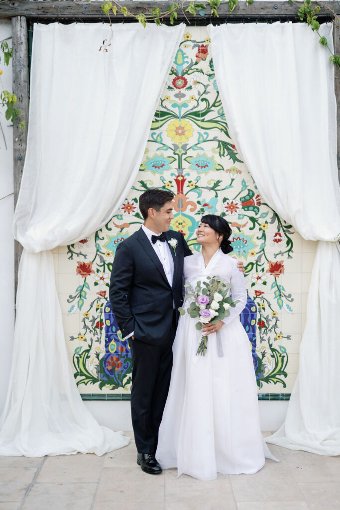 Bride and groom posing in the courtyard at La Ventura San Clemente wedding venue.