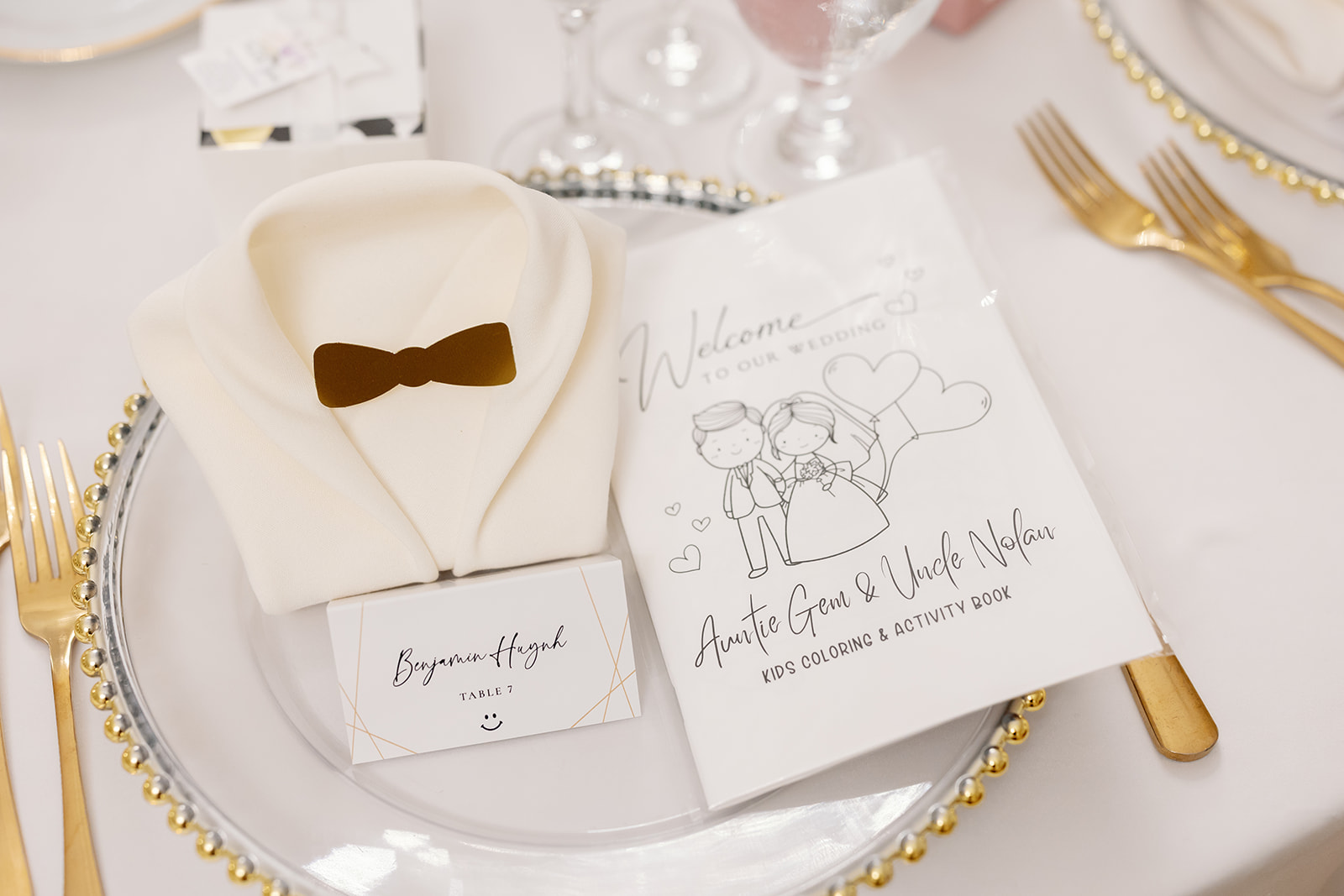 Elegant table setting with gold flatware, white plates, and custom menu card at a Nixon Library Yorba Linda wedding reception.