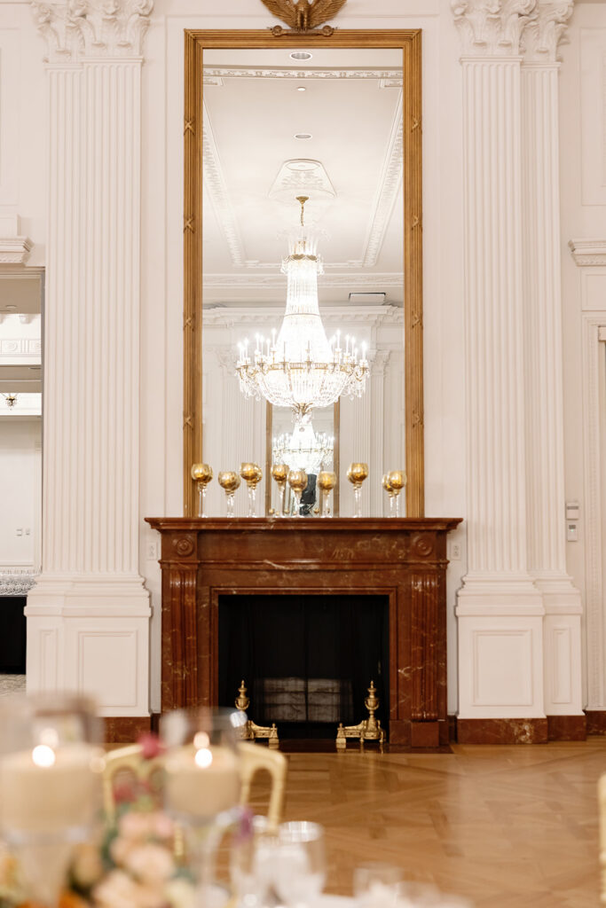 Fireplace and chandelier detail inside the East Room during a Nixon Library Yorba Linda wedding reception.