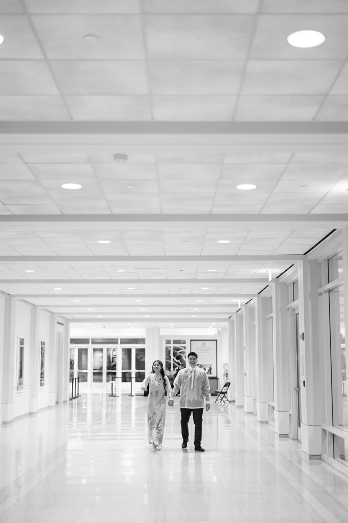 Black and white photo of a bride and groom after their reception outfit change.
