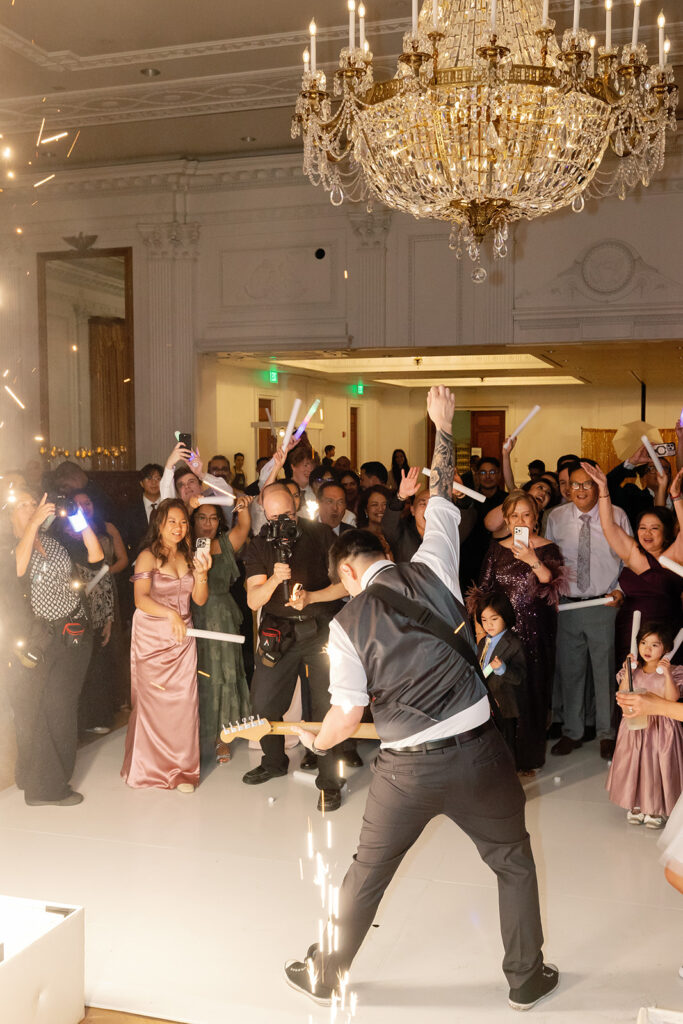 Groom giving a live concert with his guitar during his reception.