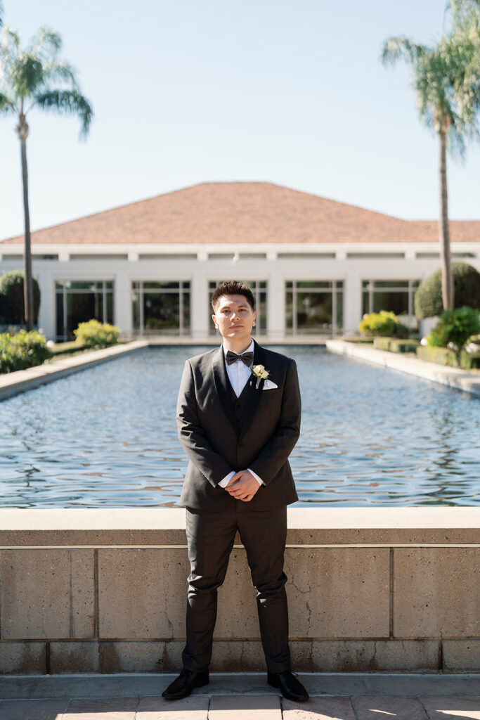 Grooms portrait in front of the reflection pool in the Rose Garden at the Nixon Library in Yorba Linda.