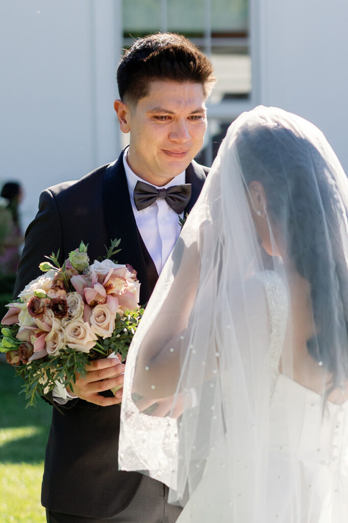 Bride and groom facing each other during an emotional first look at Nixon Library Yorba Linda wedding.