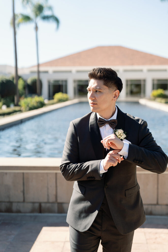 Close up shot of the groom in front of the reflection pool in the Rose Garden at the Nixon Library in Yorba Linda.