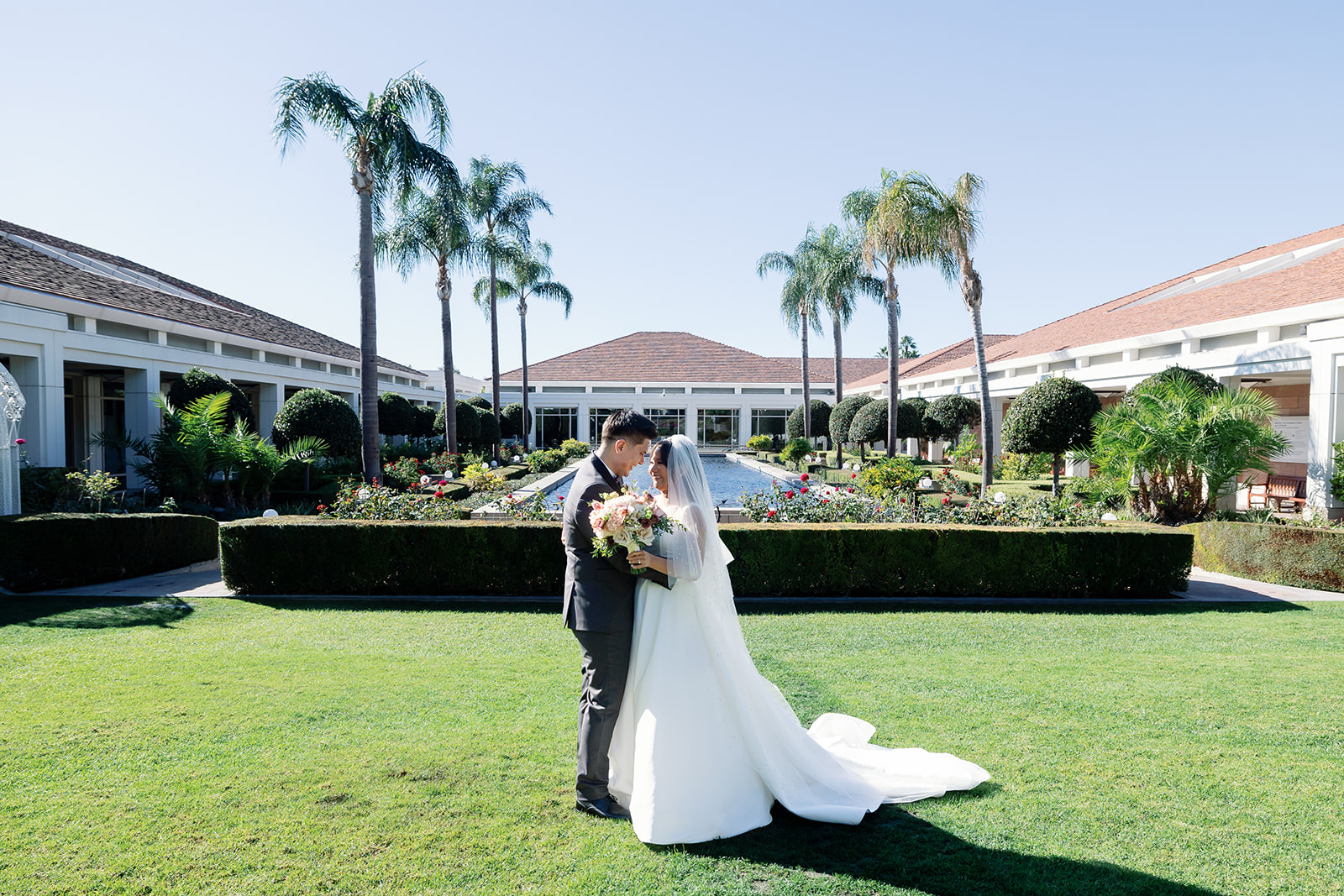 Bride and groom hugging during their first look in the Rose Garden at Nixon Library.
