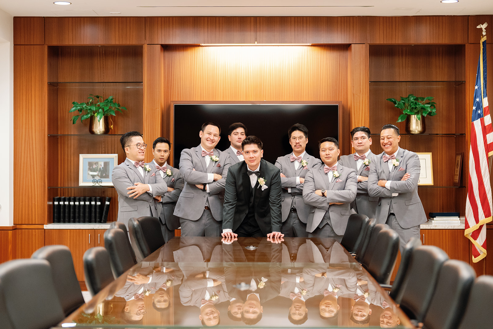 Groom posing confidently with groomsmen inside a boardroom at Nixon Library Yorba Linda wedding.