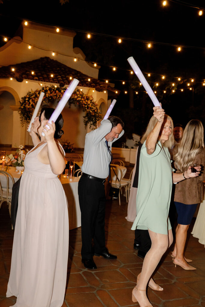 Guests dancing with glow lights during a reception at Rancho Las Lomas.