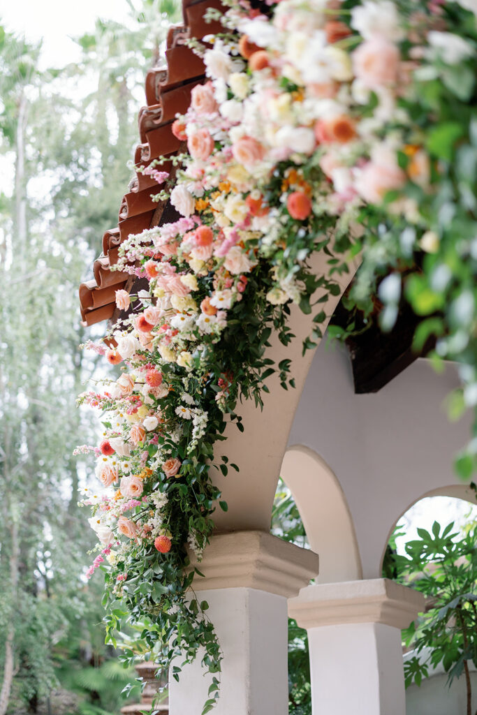 Close-up of citrus-inspired floral arch at El Teatro during a Rancho Las Lomas wedding ceremony.