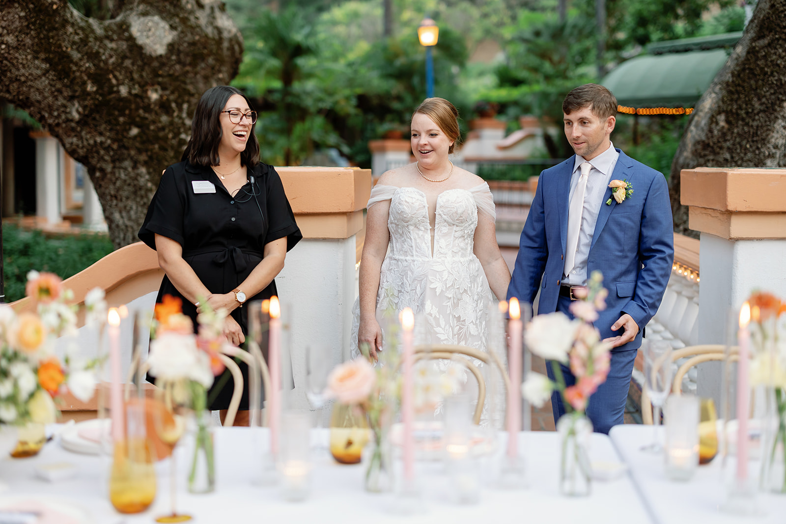 Couple entering their reception space at Rancho Las Lomas during their wedding reception reveal, reacting to the table design and florals.