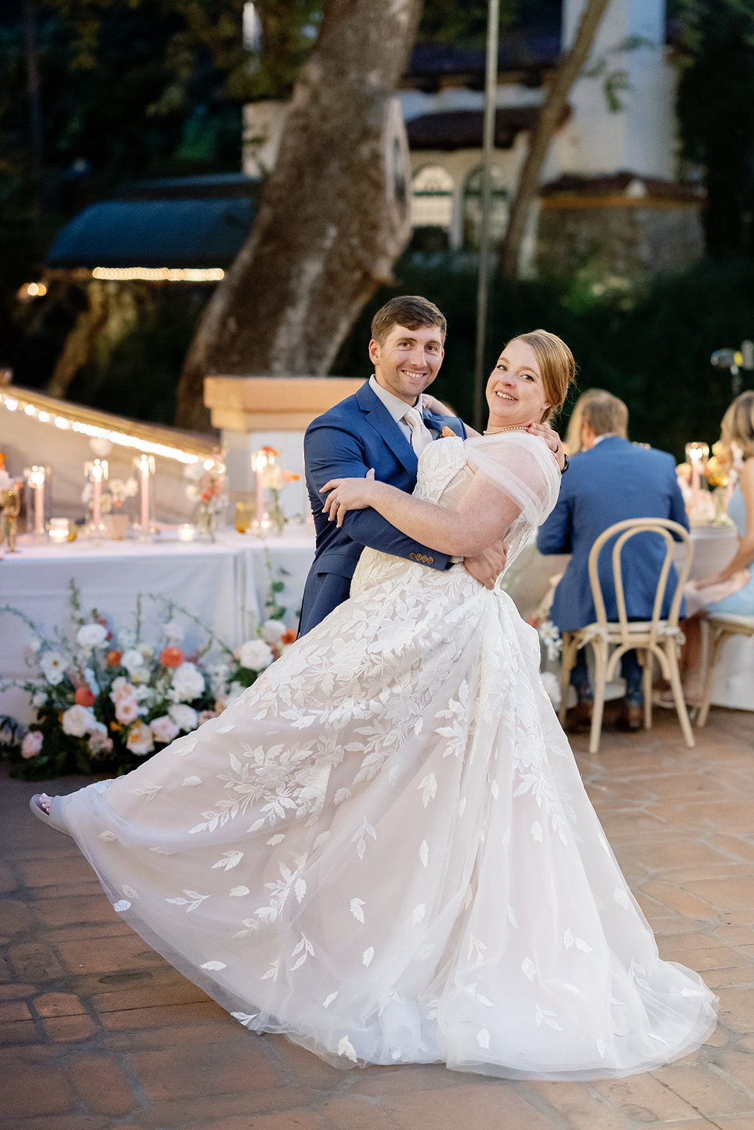 Newlyweds laughing and dancing together on the reception patio at El Teatro during a Rancho Las Lomas wedding.