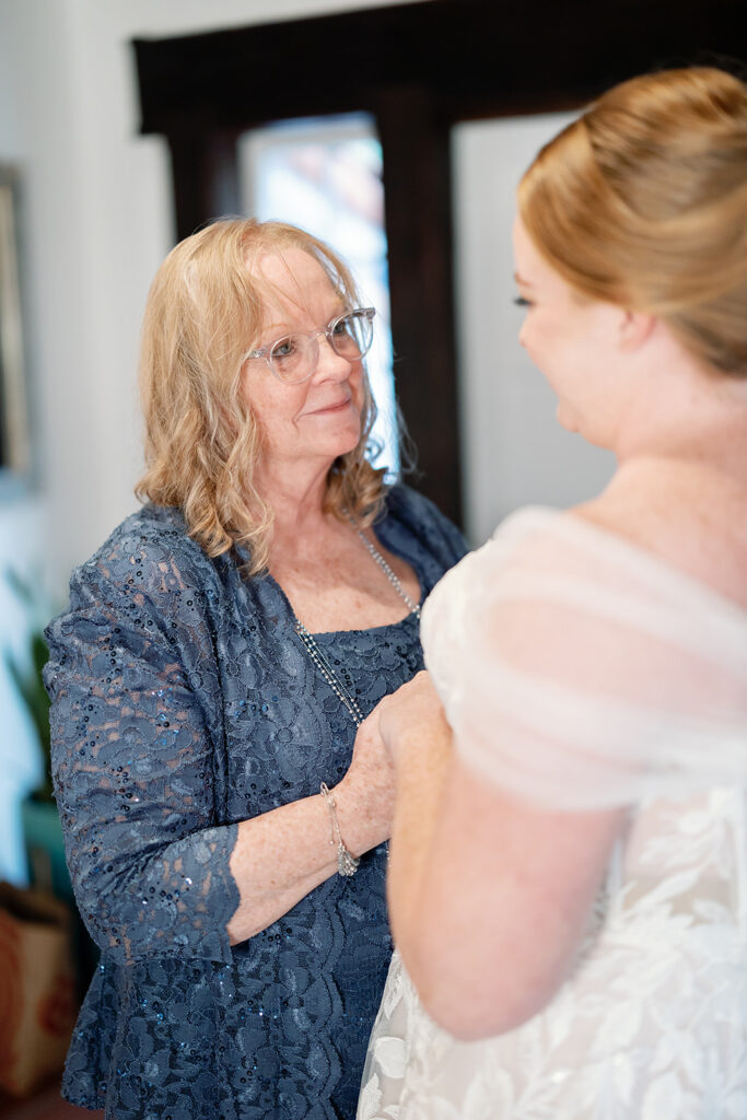 Bride sharing a quiet moment with her mother while getting ready at Rancho Las Lomas.