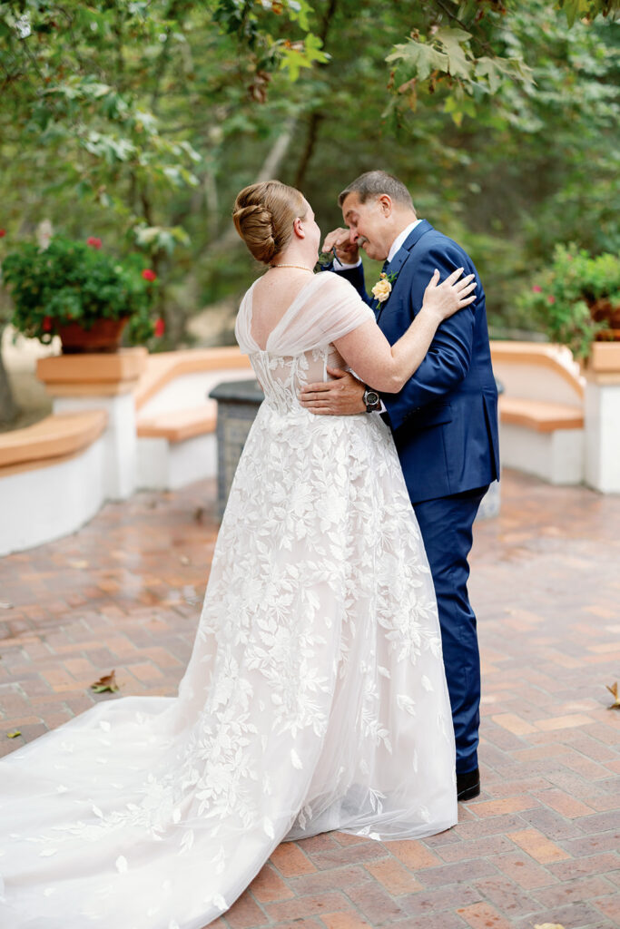 Bride sharing an emotional first look with her father.