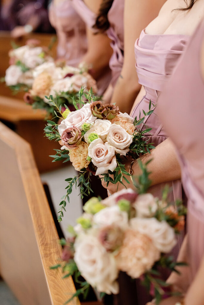 Close up shot of the bridesmaids holding their bouquets.