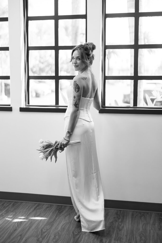 Black and white portrait of a bride posing inside Laguna Hills Civic Center in Orange County, California.