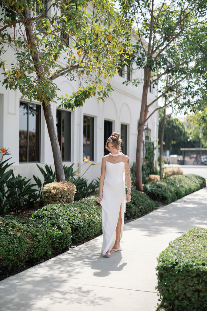 Outdoor portrait of a bride walking outside of Laguna Hills Civic Center in Orange County, California.
