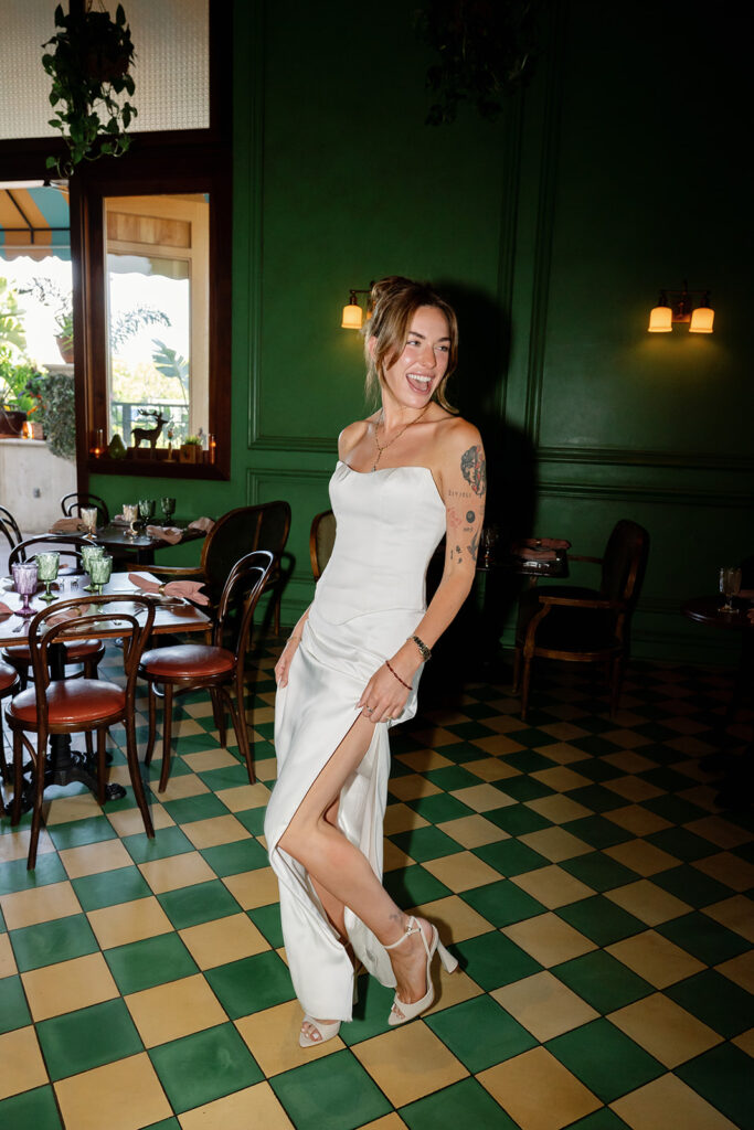 Bride posing in green tiled dining room with direct flash at Habana in Irvine Spectrum after courthouse elopement.