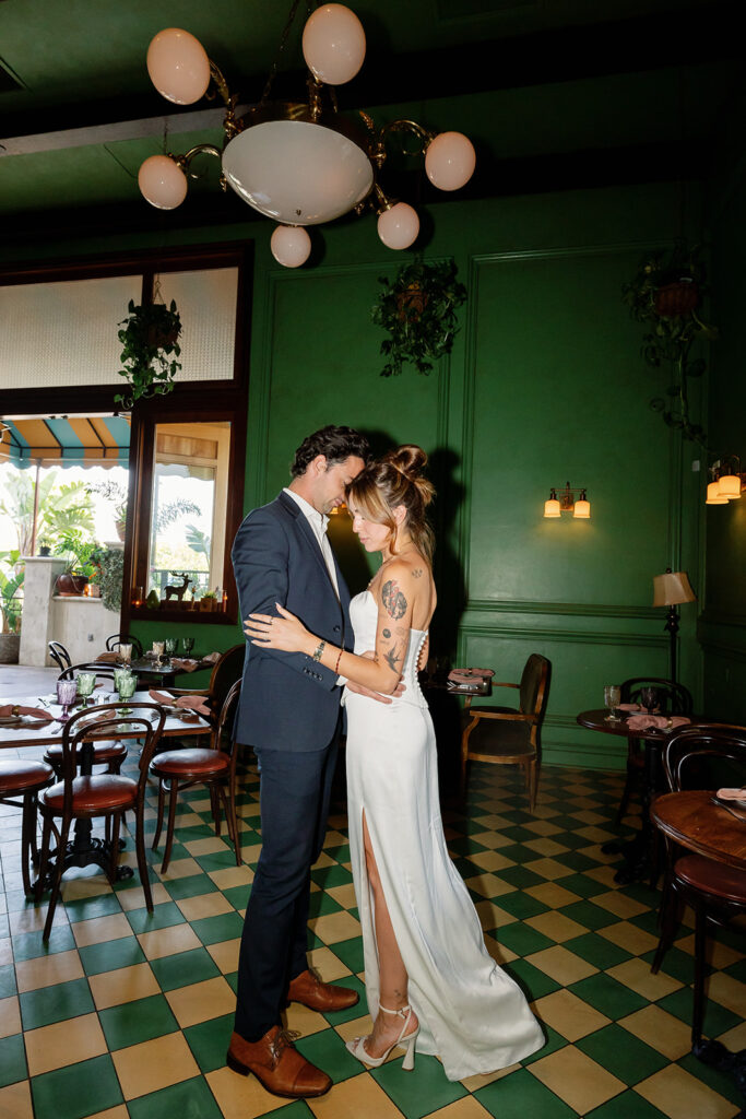 Direct flash portrait of a bride and groom standing close together at Habana in Irvine Spectrum after courthouse elopement.