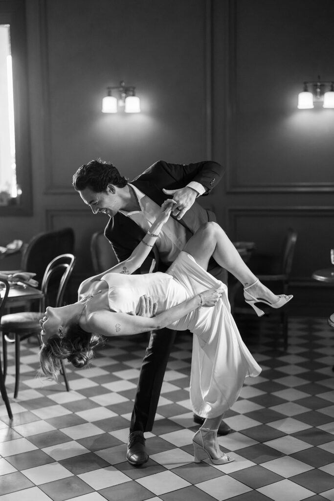 Black and white portrait of a bride and groom dancing together at Habana Irvine Spectrum after elopement.