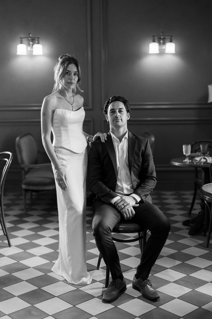 Black and white editorial style portrait of a bride and groom posing together at Habana Irvine Spectrum after elopement.