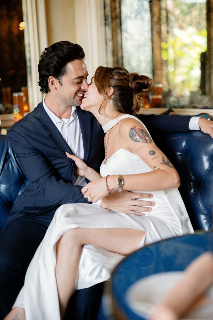 Bride and groom kissing on blue leather booth at Habana in Irvine Spectrum after Laguna Hills Courthouse elopement.