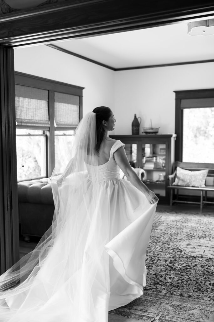 Black and white indoor portrait of the bride at San Juan Capistrano.