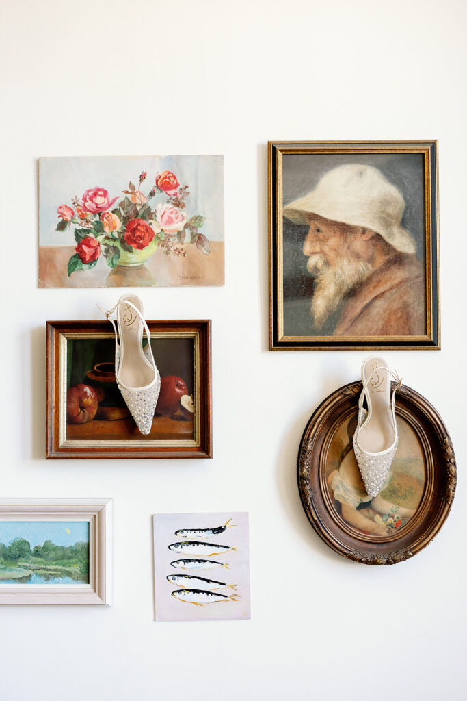 Bride’s wedding shoes displayed on gallery wall at Swanner House wedding in San Juan Capistrano.