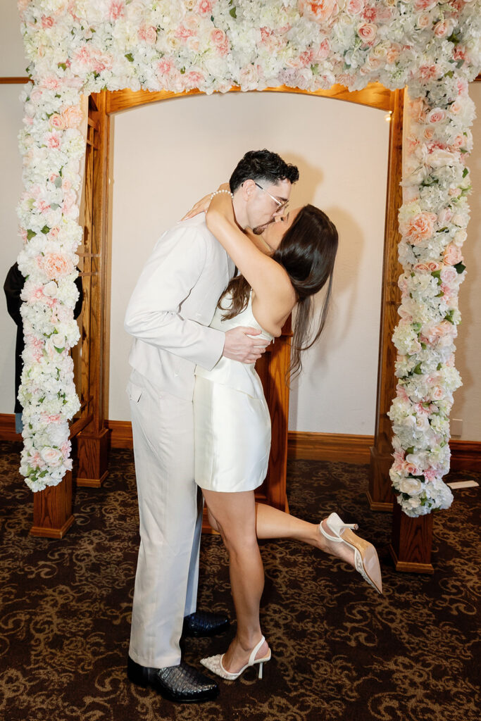 Bride and groom kissing at the altar during their Old Orange County Courthouse elopement in Santa Ana, California.