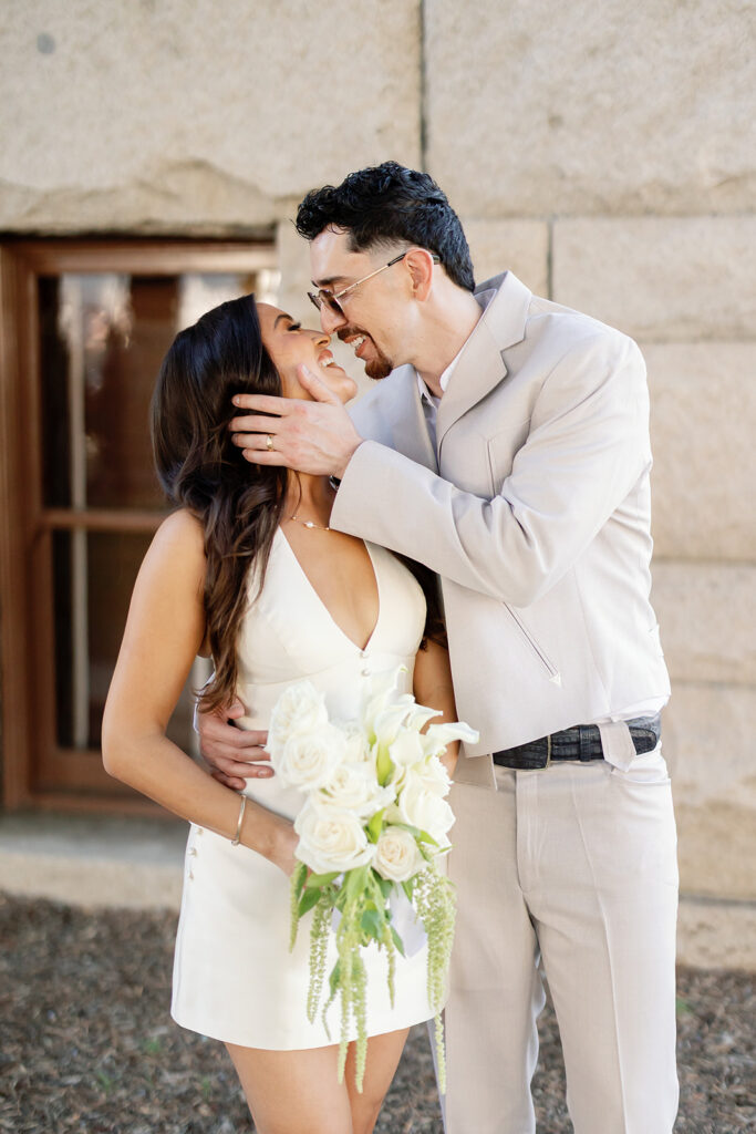 Bride and groom smiling at each other and posing for portraits.