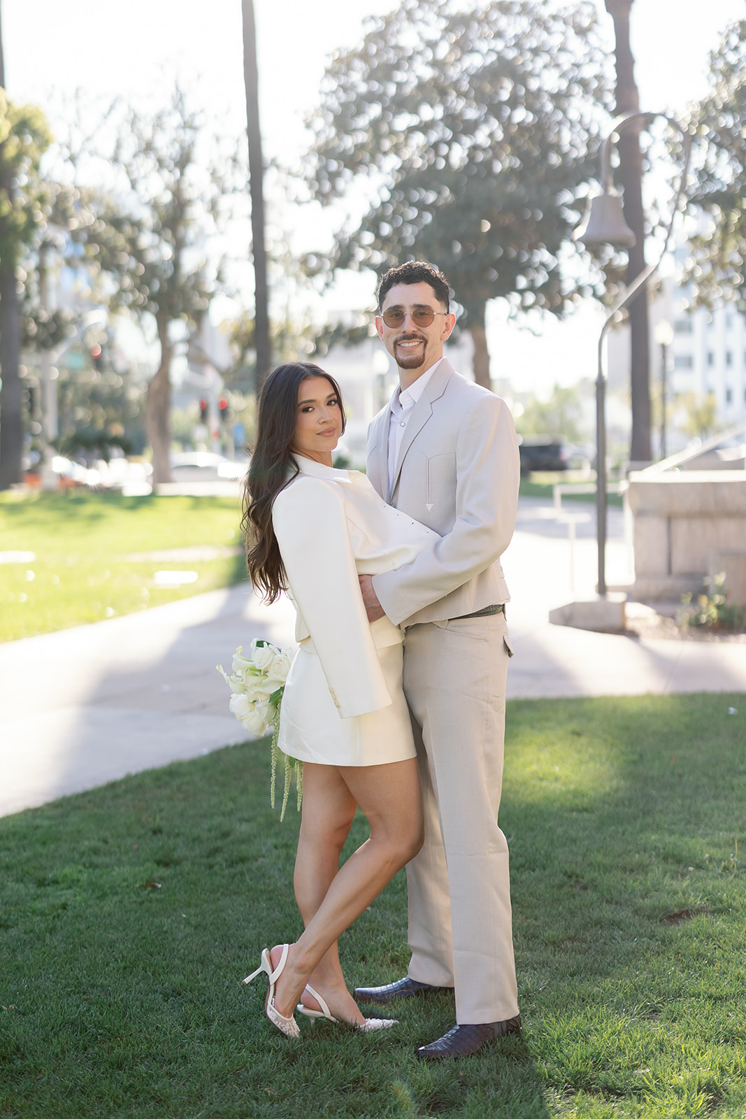 Bride and groom posing during golden hour outside of Old Orange County Courthouse in Santa Ana, California.