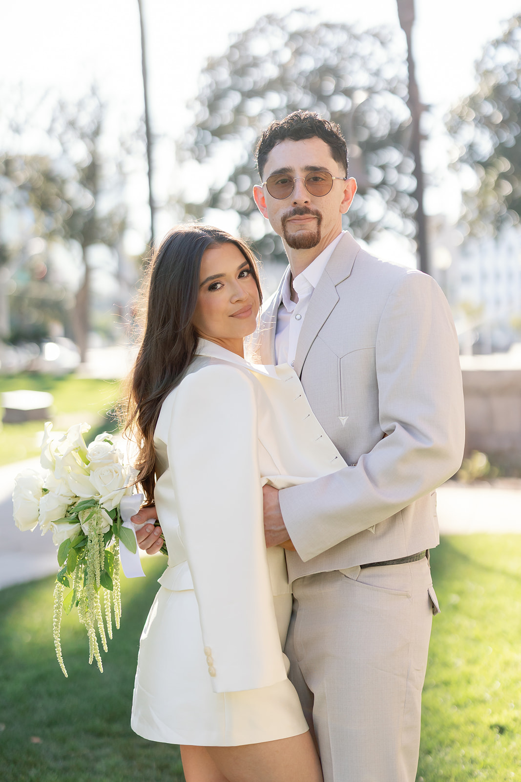 Bride and groom posing outside of Old Orange County Courthouse in Santa Ana, California.