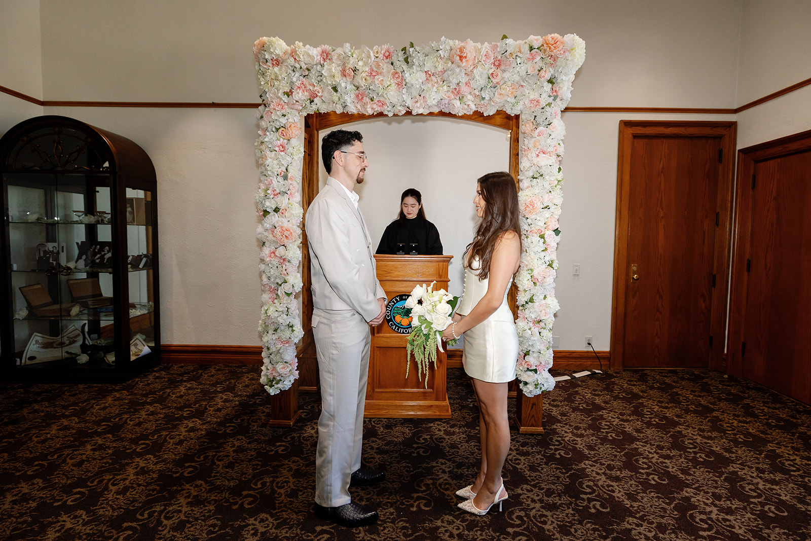 Flash photo of a bride and groom standing at the altar for their Old Orange County Courthouse elopement un Santa Ana, California.