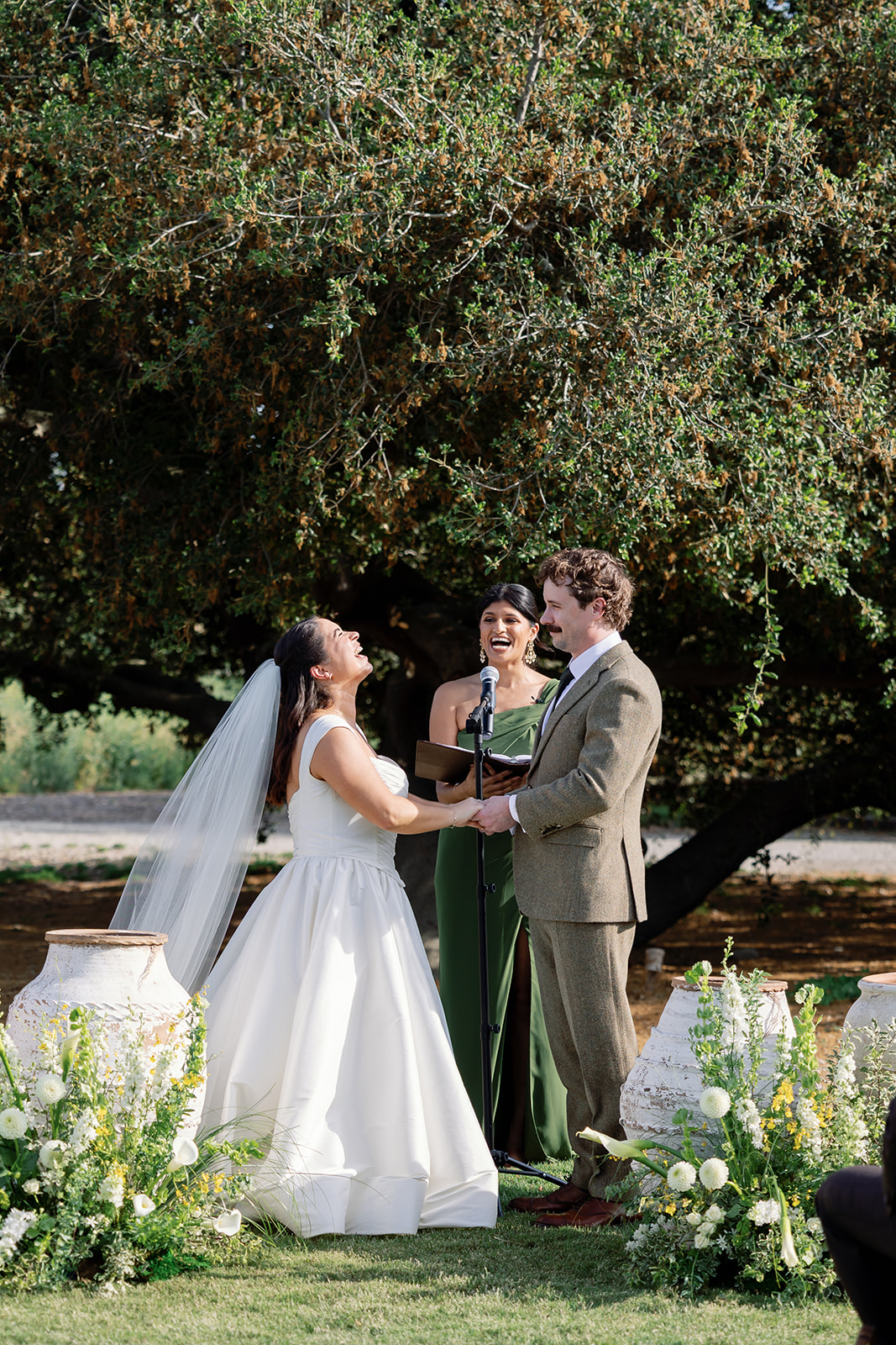 Bride and groom exchanging vows outdoors at Swanner House wedding.